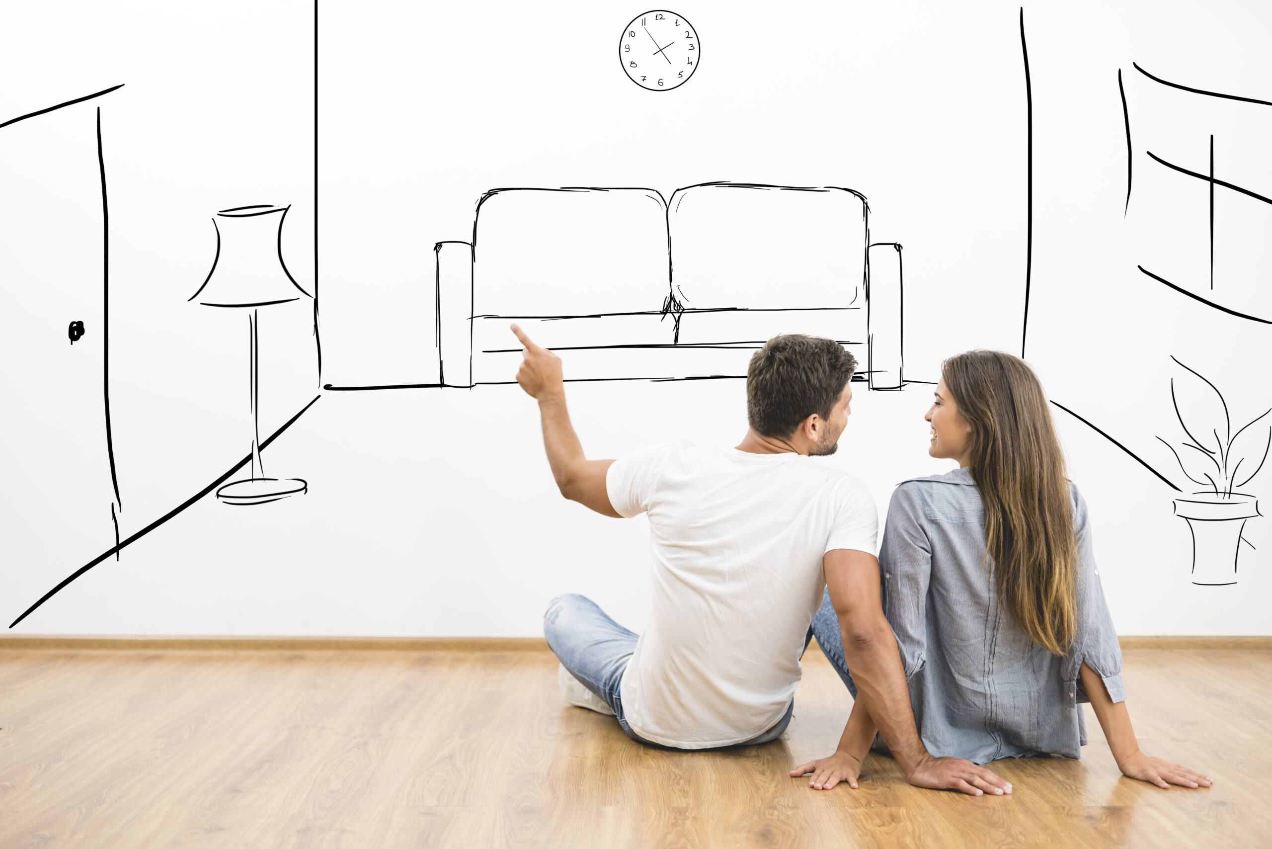 Couple looking at sketch of apartment layout